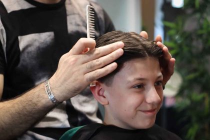 a-boy-getting-his-haircut-at-the-barbrer-shop-2023-11-27-05-15-20-utc (1)_11zon